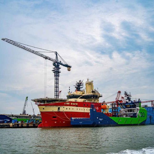 Commercial vessel and port crane supporting shipbuilding and offshore marine services